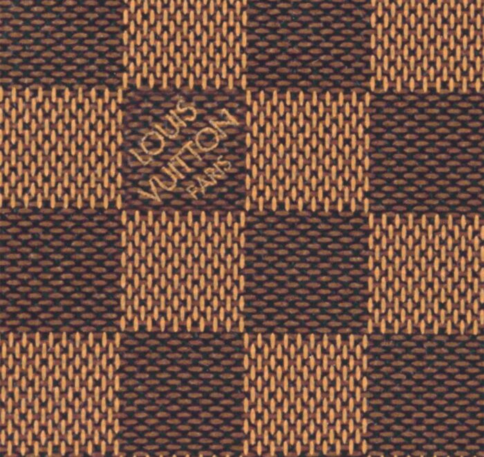 as well as the metallic LV signature on the leather luggage tag