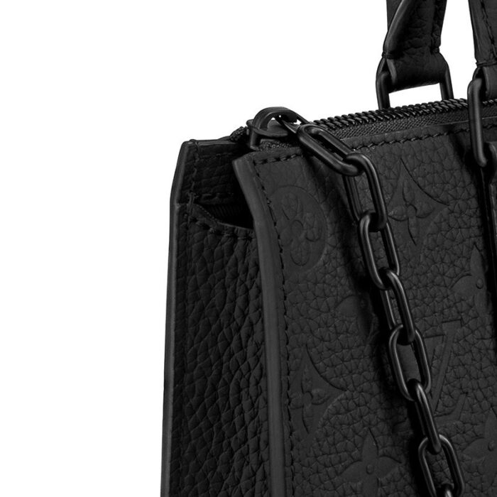 a stylishly slim yet highly practical men's carryall bag. This messenger is made from black Monogram embossed Taurillon leather and features Abloh's signature chain. The adjustable strap allows crossbody and shoulder carry.Detailed Features10.24 x 11.22 x 2.36 inches(Length x Height x Width)•Taurillon Monogram leather•Textile lining•Taurillon-leather trim•Matte-black hardware•Adjustable leather strap•Main compartment•Inside flat pocket