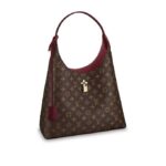 This casual-chic hobo style in the Maison's iconic canvas features a Monogram Flower padlock in shiny golden metal