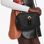 max. 61 cm/24 inches) for shoulder or cross body carry•Flat inside pocket•Double-zip closure•Double tassels attached to metal plate