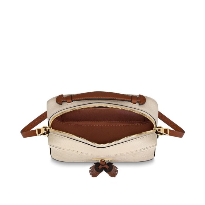 either carried by the supple top handle or suspended from the adjustable shoulder strap.Detailed Features8.66 x 6.30 x 3.15 inches(Length x Height x Width)•Crème Beige and Caramel•Embossed supple grained cowhide leather and supple grained cowhide leather•Supple grained cowhide leather trim•Microfiber lining•Gold-color hardware•Top handle•Adjustable strap (drop: min. 56 cm/22 inches