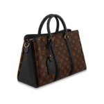 this edition of the Soufflot MM in supple Monogram canvas is richly accented with colored leather gussets and trim. The lateral bands and name tag nod to the Keepall