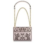 the Twist MM handbag is embellished with flowers and arabesques for Fall 2019. Traditional North African decorative designs are melded with iconic Monogram elements and embroidered on smooth leather. The gold-color LV twist-lock completes the picture.