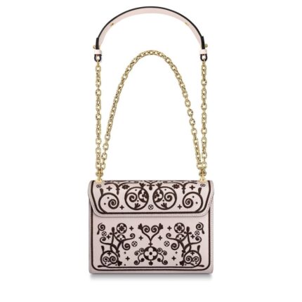 the Twist MM handbag is embellished with flowers and arabesques for Fall 2019. Traditional North African decorative designs are melded with iconic Monogram elements and embroidered on smooth leather. The gold-color LV twist-lock completes the picture.