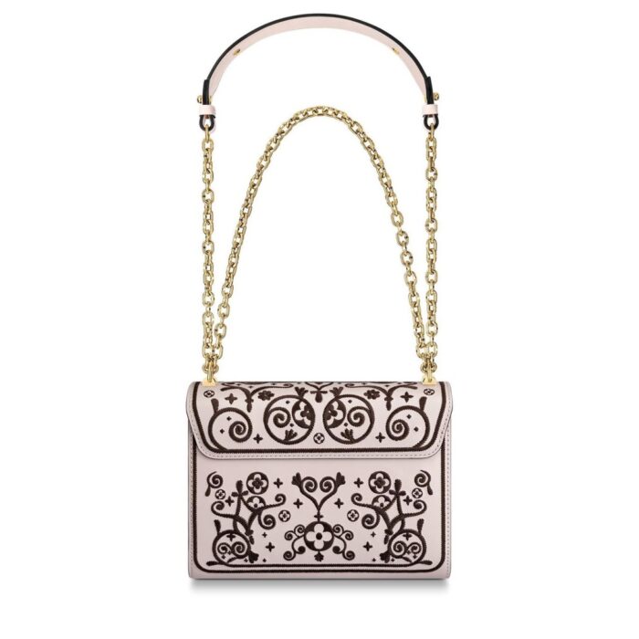 the Twist MM handbag is embellished with flowers and arabesques for Fall 2019. Traditional North African decorative designs are melded with iconic Monogram elements and embroidered on smooth leather. The gold-color LV twist-lock completes the picture.