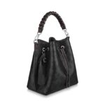 either by the braided top handle or the long leather strap