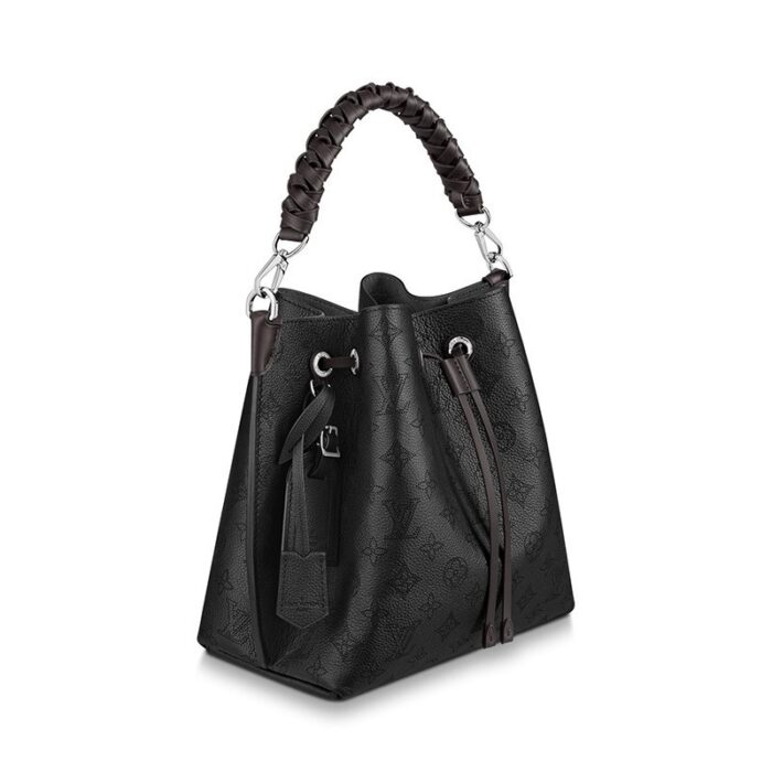 either by the braided top handle or the long leather strap