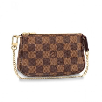 The Mini Pochette Accessoires in Damier Ebene canvas is the perfect way to carry essentials. Its supple