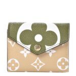 This stylish coin purse features an oversized monogram print on toile coated canvas in green and beige. The front flap opens to a beige cross grained leather interior with card slots