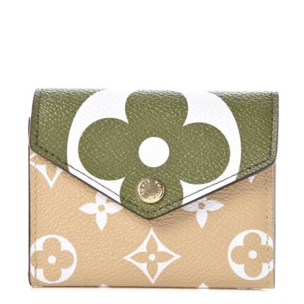 This stylish coin purse features an oversized monogram print on toile coated canvas in green and beige. The front flap opens to a beige cross grained leather interior with card slots