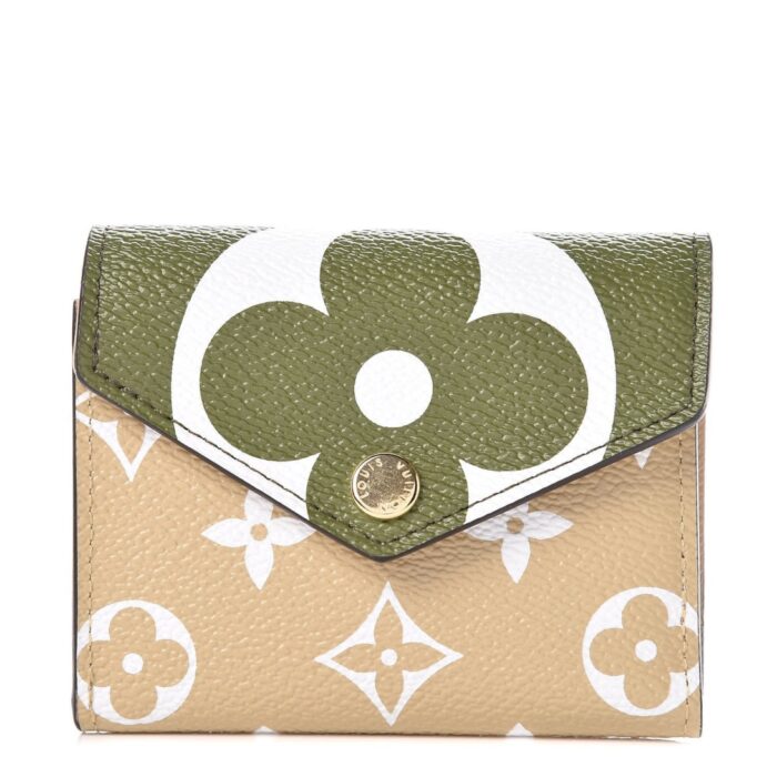 This stylish coin purse features an oversized monogram print on toile coated canvas in green and beige. The front flap opens to a beige cross grained leather interior with card slots