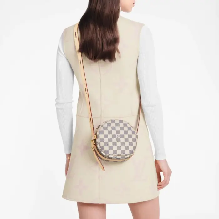 sans-serif; font-size: 16px; background-color: #ffffff;">For Summer 2020. Louis Vuitton introduces a miniature version of the soft-sided Boite Chapeau Souple PM handbag in Damier Azur canvas. Combining classic House details such as the gold-tone padlock and natural cowhide-leather trim with a side buckle and adjustable strap. this hatbox-shaped bag becomes irresistible.Detailed Features6.69 x 6.30 x 2.76 inches(Length x Height x Width)Damier Azur coated canvasNatural cowhide-leather trimMicrofiber liningGold-color hardwareLeather adjustable strap (drop: min. 42 cm/16.5 inches. max. 56 cm/22.1 inches)Curved side bucklesDouble zip closure with leather zip pullsPadlockInside flat card pocket