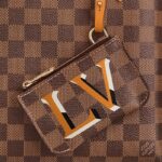 it is also fitted with a removable strap for shoulder or cross-body wear. This sleek