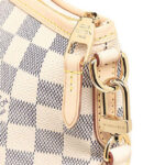 captured in a beautifully crafted bag. The Riviera in Damier Azur travels with laid-back elegance from brunch to shopping to cocktails by the pool. The coated canvas body in summery Damier Azur features natural cawhide accents – intricately braided handles