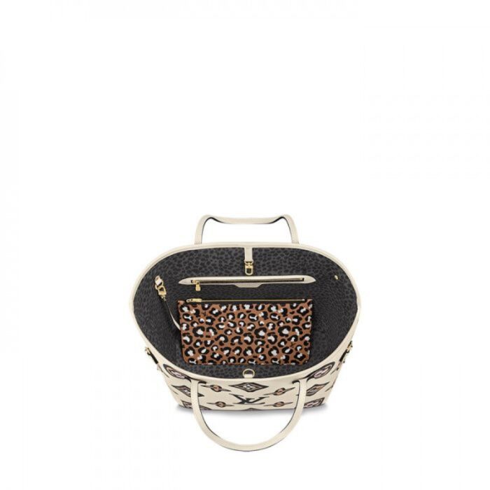 hand-painted look. This roomy carryall can be slipped over the shoulder or elbow and comes with a separate zipped pouch that can serve as a clutch or extra pocket.