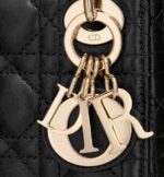 its iconic silhouette is embellished with a 'D.I.O.R.' charm. The micro style can accommodate all the daily essentials and features an adjustable and removable shoulder strap