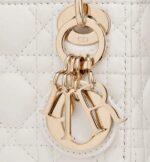its iconic silhouette is embellished with a 'D.I.O.R.' charm. The micro Lady Dior bag can accommodate all the daily essentials and features an adjustable and removable shoulder strap