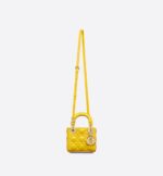 its iconic silhouette is embellished with a 'D.I.O.R.' charm. The micro Lady Dior bag can accommodate all the daily essentials and features an adjustable and removable shoulder strap