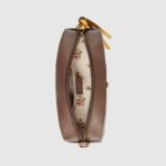 this camera bag has yellow leather details. The contrast trims pay homage to the House’s past