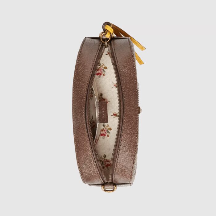 this camera bag has yellow leather details. The contrast trims pay homage to the House’s past