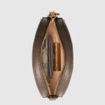 an archival Gucci code from the '70s that appears atop a leather tab detail and on the zipper pull.