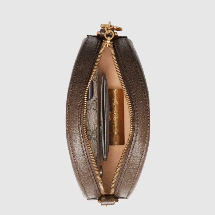 an archival Gucci code from the '70s that appears atop a leather tab detail and on the zipper pull.