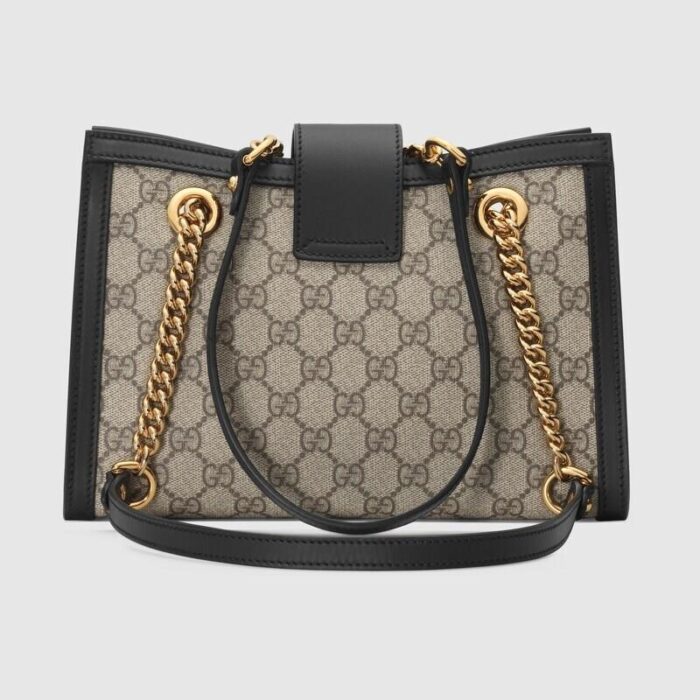 this structured shoulder bag features shoulder straps with a key-lock closure straight from the archive. Keys are stored in a removable leather key pouch.