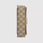 the Padlock is defined by its signature lock and key closure. The accessory is crafted from beige and ebony GG Supreme canvas with a white leather top. Adding a pop of color