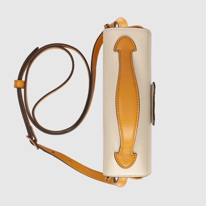 burnt orange leather details complete the mini bag.