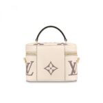 embossed with the Giant Monogram motif. Its tassel zip pulls