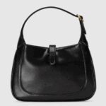 detachable shoulder strap. Attached to the bag with a buckle closure