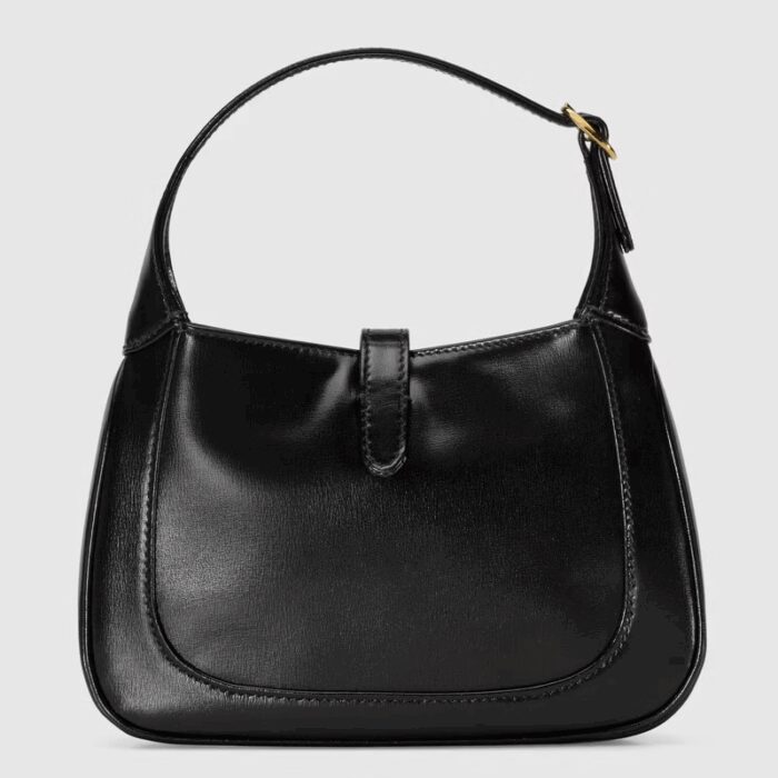 detachable shoulder strap. Attached to the bag with a buckle closure
