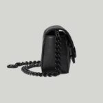 here it appears atop a GG Marmont belt bag crafted from black chevron matelassé leather.