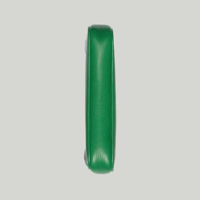 it's presented in a soft green leather with a gold-toned zip closure.