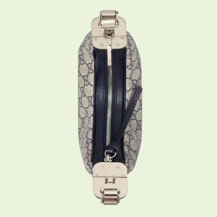 this small shoulder bag further defined by a G shaped hook closure. Paired with soft materials