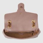 changing between a shoulder and a top handle bag. Made in matelassé chevron leather with a heart on the back.