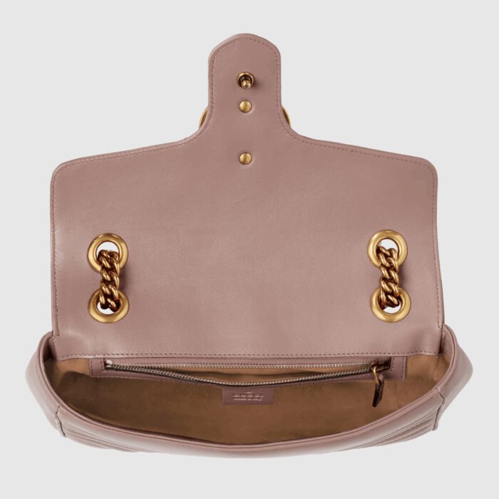 changing between a shoulder and a top handle bag. Made in matelassé chevron leather with a heart on the back.