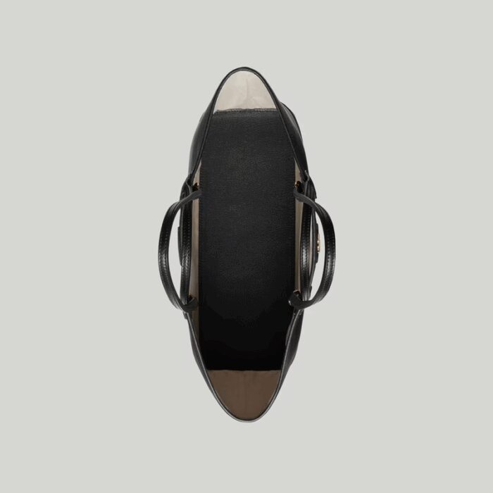 presented across a soft black leather base.