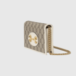 completed with a detachable chain strap. The style is completed with white leather details.