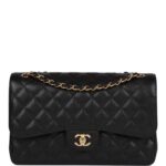 This Jumbo Classic Double Flap bag is in?black caviar leather with?gold tone hardware and features a front flap with signature CC turnlock closure