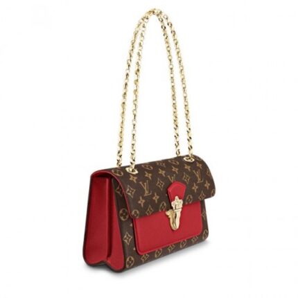 while the sliding chain strap echoes the Malletage print that lined those historic trunks. Large enough to fit a long wallet