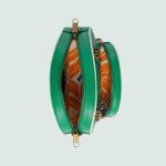 emblematic House’s motifs mix with those of the historic sportswear brand adidas resulting in a series of hybrid looks. This shoulder bag has a Gucci Trefoil print decorating the front pocket.